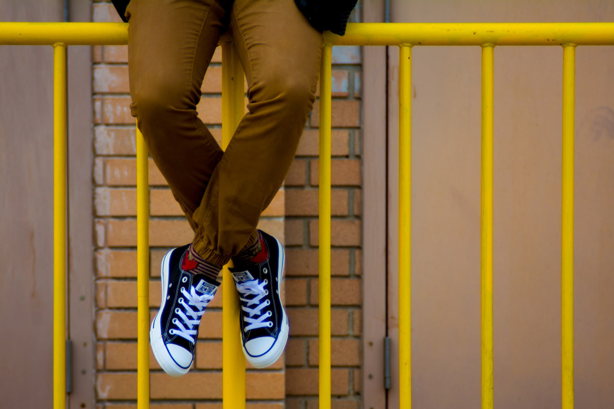 Youth on yellow fence