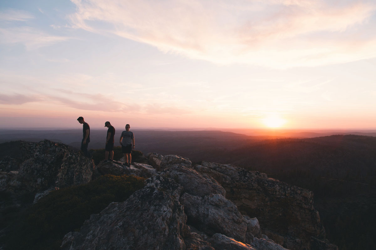 Young Adults on a mountain top at sunset