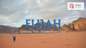 man in a long robe walking in the desert